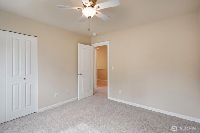 unfurnished bedroom featuring a closet, carpet flooring, ceiling fan, and baseboards