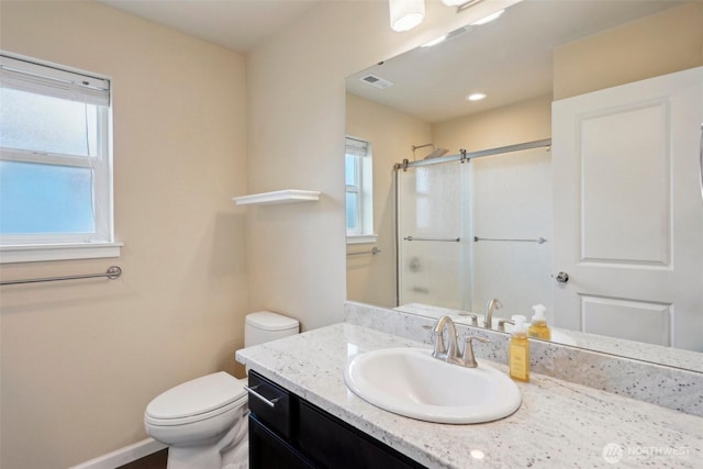 bathroom featuring visible vents, baseboards, toilet, an enclosed shower, and vanity