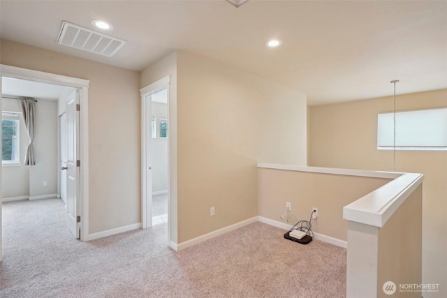 corridor featuring visible vents, an upstairs landing, recessed lighting, carpet floors, and baseboards