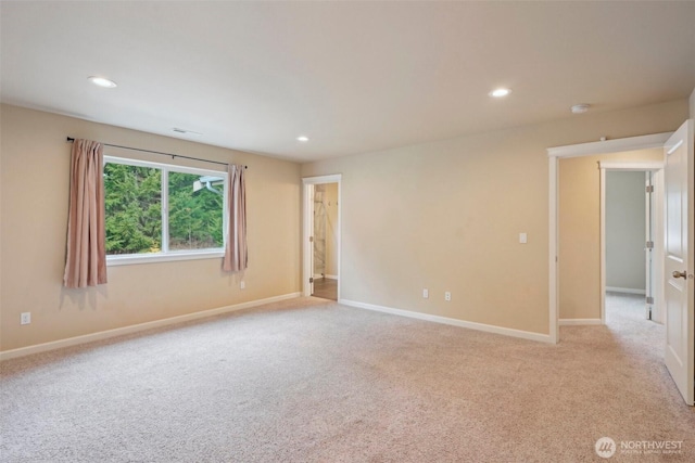 unfurnished room featuring recessed lighting, baseboards, and light carpet