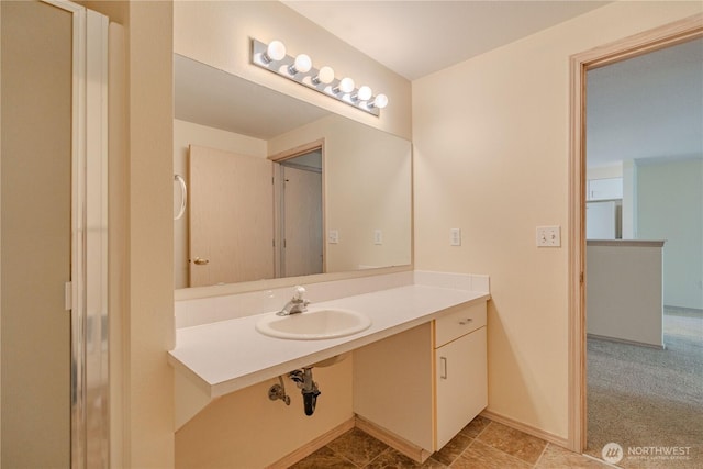 bathroom featuring baseboards and a sink