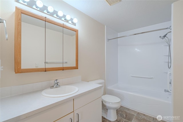 full bath with vanity, toilet, visible vents, tub / shower combination, and a textured ceiling