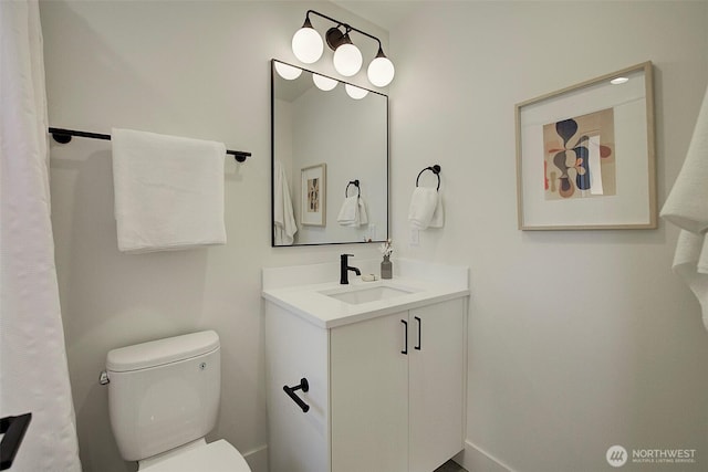 bathroom with toilet and vanity