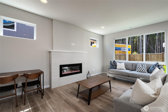 2406 SW Ridgeway Dr, Oak Harbor, WA 98277 - living room with a tiled fireplace, baseboards, wood finished floors, and recessed lighting