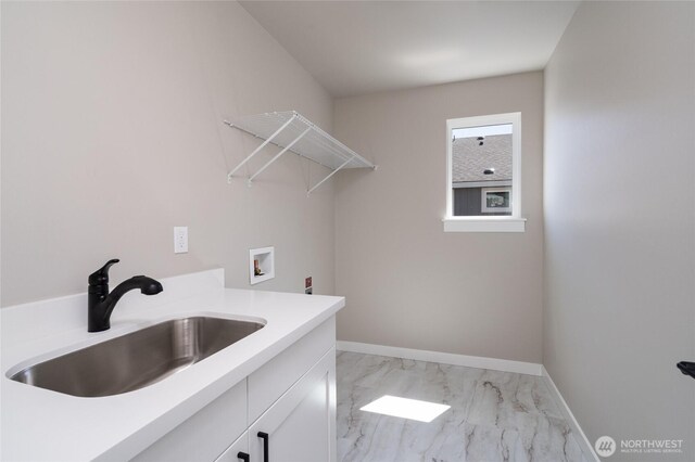 2406 SW Ridgeway Dr, Oak Harbor, WA 98277 - laundry room with cabinet space, light marble finish flooring, washer hookup, and baseboards