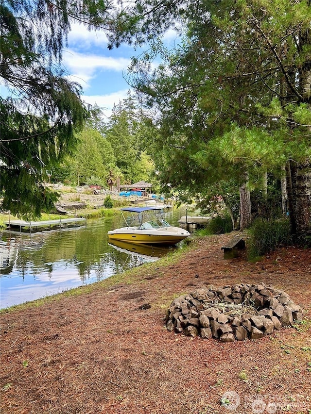 exterior space featuring a boat dock and an outdoor fire pit