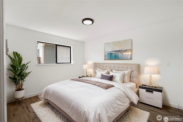 bedroom featuring baseboards and wood finished floors