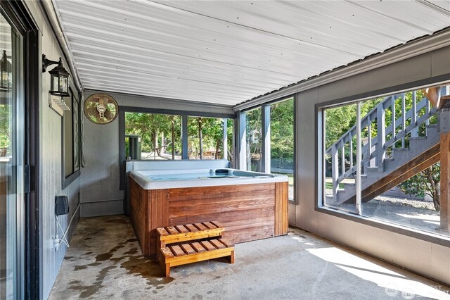 sunroom featuring a hot tub