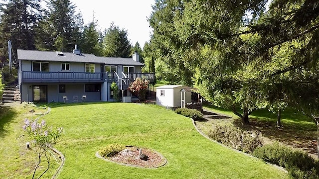 view of yard featuring stairway, a deck, an outdoor structure, and a storage unit