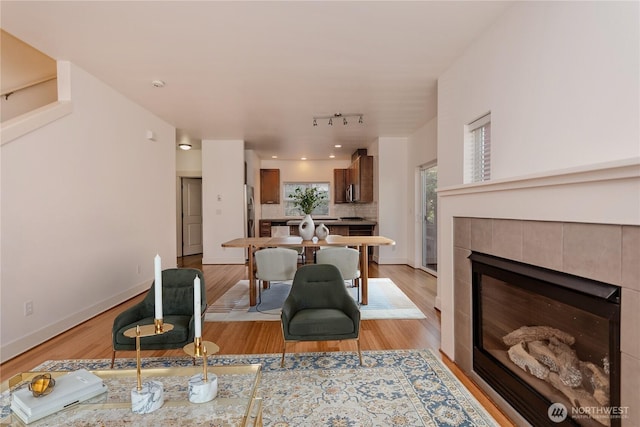5913 31st Ave SW, Seattle, WA 98126 - living area with light wood-style floors, baseboards, and a fireplace