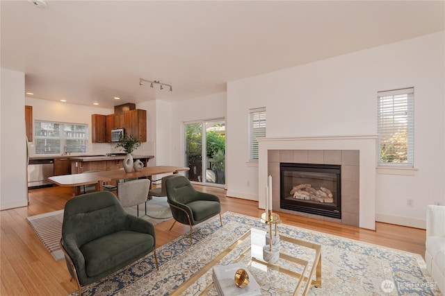 5913 31st Ave SW, Seattle, WA 98126 - living room with baseboards, light wood-style flooring, and a fireplace