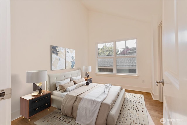 5913 31st Ave SW, Seattle, WA 98126 - bedroom with light wood-type flooring, baseboards, and high vaulted ceiling