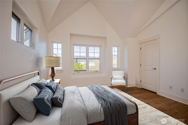 5913 31st Ave SW, Seattle, WA 98126 - bedroom with multiple windows, baseboards, wood finished floors, and vaulted ceiling