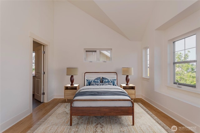 5913 31st Ave SW, Seattle, WA 98126 - bedroom with light wood-style flooring, baseboards, and lofted ceiling