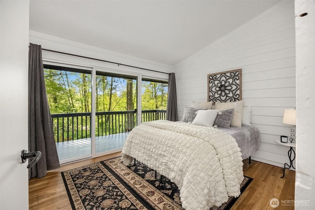 11925 Manzanita Ln NE, Bainbridge Island, WA 98110 - bedroom with vaulted ceiling, access to outside, wood finished floors, and wooden walls