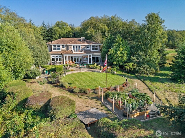 1935 False Bay Dr, Friday Harbor, WA 98250 - rear view of property featuring a garden, a lawn, and a chimney