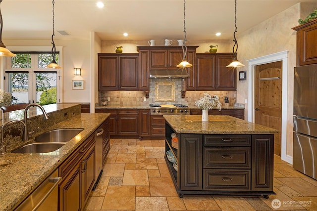 1935 False Bay Dr, Friday Harbor, WA 98250 - kitchen featuring a sink, stone tile flooring, stainless steel appliances, tasteful backsplash, and recessed lighting