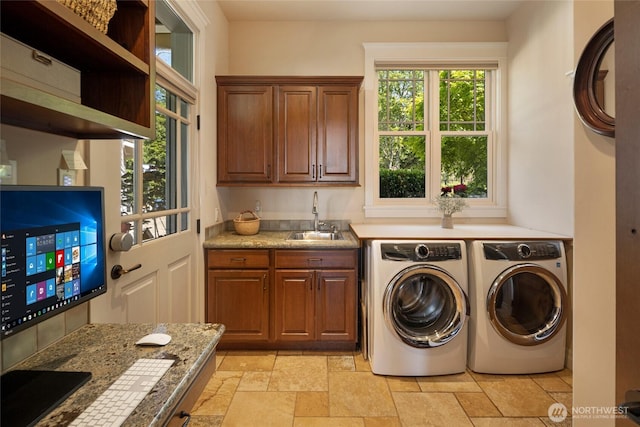 1935 False Bay Dr, Friday Harbor, WA 98250 - clothes washing area featuring washing machine and clothes dryer, cabinet space, and stone tile flooring