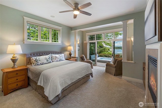 1935 False Bay Dr, Friday Harbor, WA 98250 - carpeted bedroom featuring access to outside, multiple windows, a tiled fireplace, and baseboards