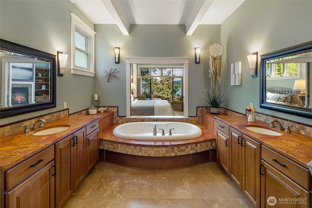 1935 False Bay Dr, Friday Harbor, WA 98250 - ensuite bathroom featuring two vanities, a garden tub, and a glass covered fireplace