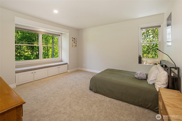 1935 False Bay Dr, Friday Harbor, WA 98250 - bedroom featuring multiple windows, light carpet, baseboards, and recessed lighting