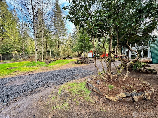 view of street featuring gravel driveway