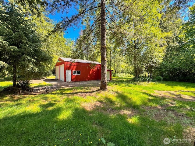 13811 Thompson Rd Unit 11, Cinebar, WA 98533 - view of green lawn featuring a detached garage and an outdoor structure
