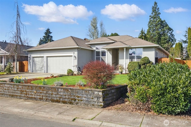 single story home with an attached garage, fence, concrete driveway, and a front yard