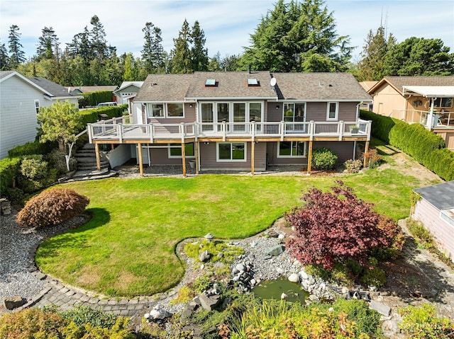 8196 Comox Rd, Blaine, WA 98230 - rear view of house featuring a wooden deck, a yard, stairs, and a small pond