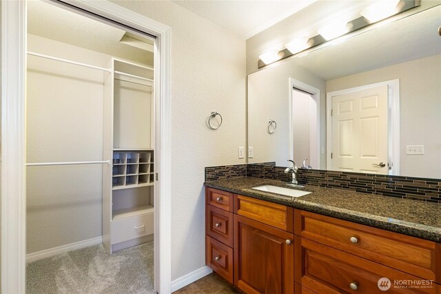 8196 Comox Rd, Blaine, WA 98230 - bathroom featuring vanity, baseboards, and backsplash