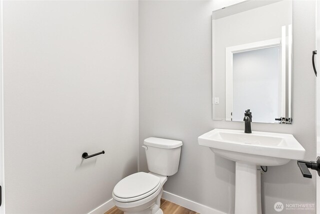 13906 178th Street Ct E Unit 62, Puyallup, WA 98374 - half bath featuring baseboards, wood finished floors, and toilet