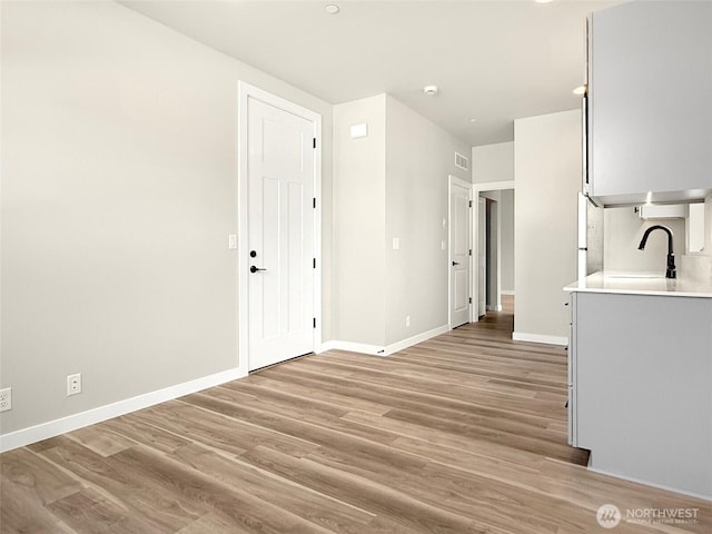13906 178th Street Ct E Unit 62, Puyallup, WA 98374 - interior space with a sink, light wood finished floors, light countertops, and baseboards