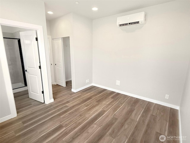 13906 178th Street Ct E Unit 62, Puyallup, WA 98374 - unfurnished bedroom with a wall mounted air conditioner, wood finished floors, baseboards, recessed lighting, and a closet
