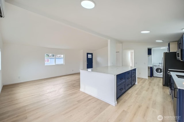 7110 146th St SW Unit 35, Lakewood, WA 98439 - kitchen with open floor plan, washer / dryer, light wood-type flooring, and appliances with stainless steel finishes