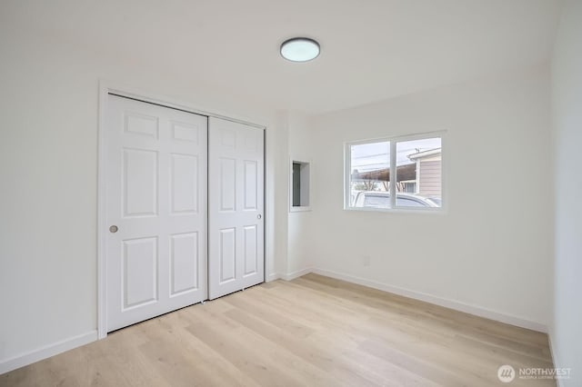 7110 146th St SW Unit 35, Lakewood, WA 98439 - unfurnished bedroom with a closet, light wood finished floors, and baseboards