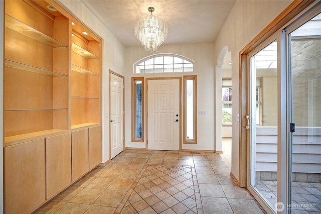 1433 Crestview Dr, Camano Island, WA 98282 - entryway with a chandelier, arched walkways, healthy amount of natural light, and baseboards