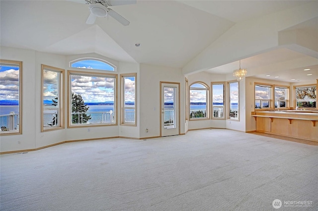 1433 Crestview Dr, Camano Island, WA 98282 - unfurnished living room with vaulted ceiling, a chandelier, carpet floors, baseboards, and a ceiling fan