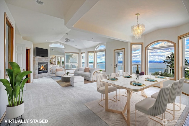 1433 Crestview Dr, Camano Island, WA 98282 - dining area with lofted ceiling, a water view, a fireplace, a chandelier, and carpet floors