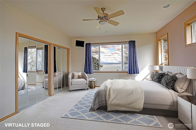 1433 Crestview Dr, Camano Island, WA 98282 - bedroom featuring light colored carpet, two closets, and a ceiling fan