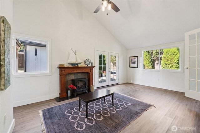 817 SW 158th St, Burien, WA 98166 - living room with high vaulted ceiling, french doors, a wood stove, ceiling fan, and wood finished floors