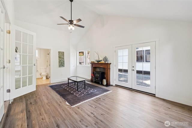 817 SW 158th St, Burien, WA 98166 - living area with french doors, a ceiling fan, wood finished floors, high vaulted ceiling, and a wood stove