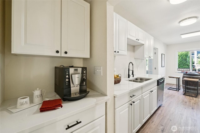 817 SW 158th St, Burien, WA 98166 - kitchen featuring dishwasher, light wood finished floors, light countertops, and white cabinets