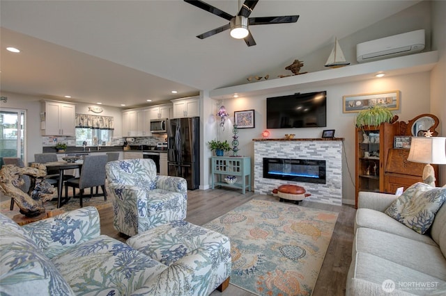 1436 Sand Pebble Ave SW, Ocean Shores, WA 98569 - living area with ceiling fan, an AC wall unit, light wood-type flooring, vaulted ceiling, and recessed lighting