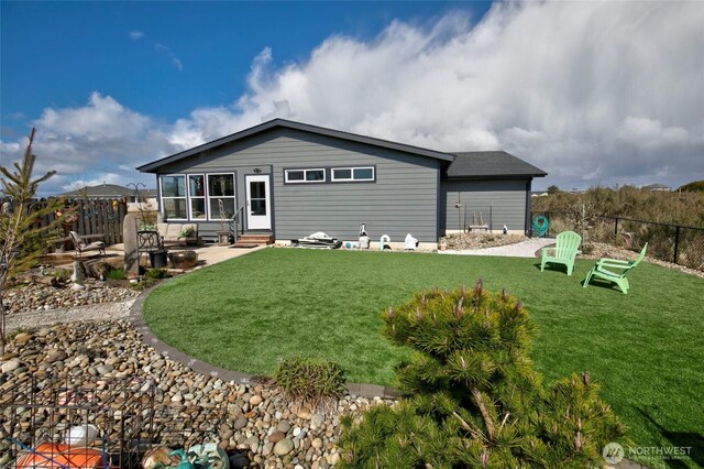 1436 Sand Pebble Ave SW, Ocean Shores, WA 98569 - rear view of house featuring a yard, fence, and entry steps