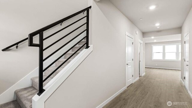 10591 135th Ave NE Unit 24, Kirkland, WA 98033 - hallway with wood finished floors, stairway, baseboards, and recessed lighting
