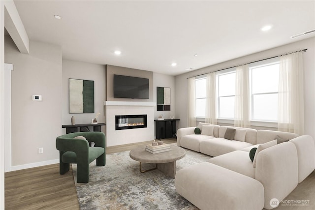 10591 135th Ave NE Unit 24, Kirkland, WA 98033 - living room featuring wood finished floors, recessed lighting, baseboards, and a glass covered fireplace