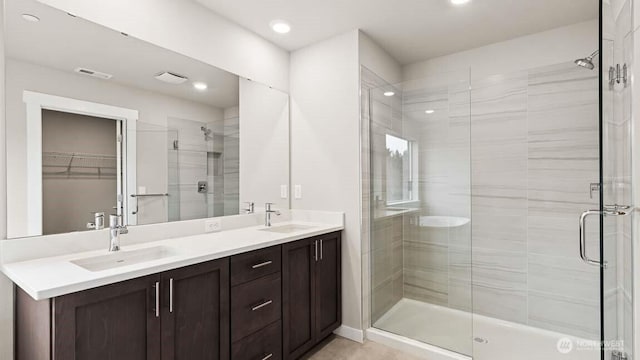 10591 135th Ave NE Unit 24, Kirkland, WA 98033 - full bathroom featuring a stall shower, double vanity, recessed lighting, and a walk in closet