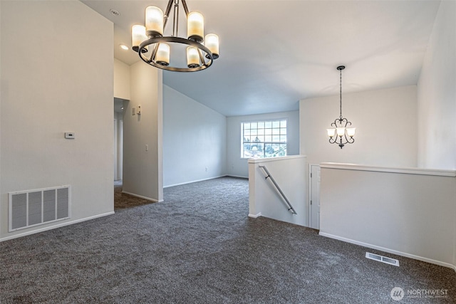 spare room with visible vents, dark carpet, lofted ceiling, and a notable chandelier