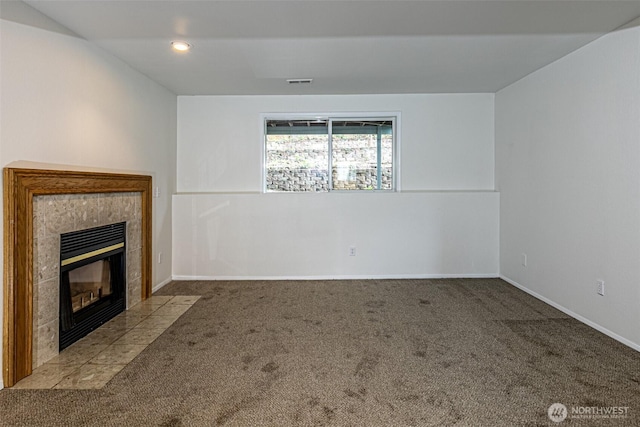 unfurnished living room with a fireplace, baseboards, carpet, and visible vents