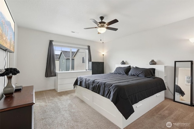 bedroom with a ceiling fan, baseboards, visible vents, and carpet